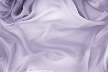 The texture of the satin fabric of lilac color for the background