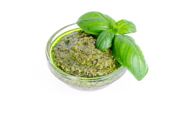 Pesto sauce and fresh green basil leaves. 