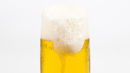 glass of beer with foam isolated on white