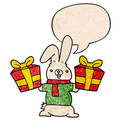cartoon rabbit and christmas presents and speech bubble in retro texture style