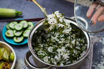 Asian Chinese rice with laminaria seaweeds or hot Indian basmati white rice in steel pot