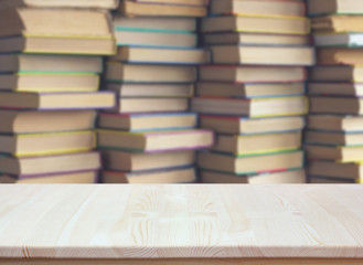 empty wooden table on blurred background of books. empty Desk.