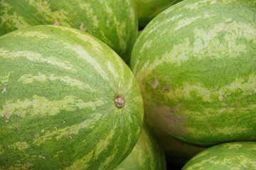 Close up full frame view of watermelons displayed for sale at a market stand