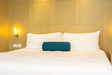 Fototapeta na wymiar Beautiful white pillow and blanket on bed decoration interior