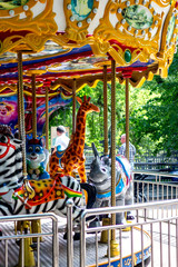 children's merry-go-rounds circling colorful bright animals in summer