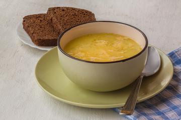 Cheese and onion soup in a bowl on a table