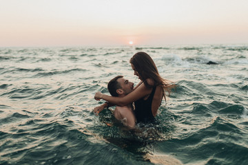 lovely couple kissing in the sea