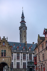 Fototapeta premium The dramatic tower of The Poortersloge (Burgher’s Lodge) in slight morning fog. It was built in 14 century and served as meeting spot for the Society of the White Bear, a society of burghers.