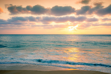 Naklejka na ściany i meble Sunset over the sea. Atlantic ocean in evening, sandy beach