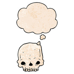 cartoon spooky skull and thought bubble in grunge texture pattern style
