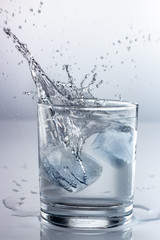 spray water in a glass on a gray background