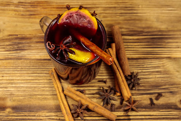 Mulled wine and spices on wooden table