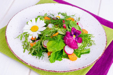 Bright vegan summer salad on white plate