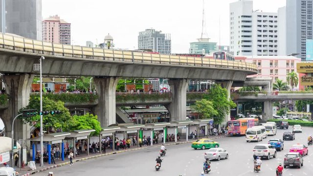 Time lapse of Sky train and car traffic moving from the  victory monument station in Bangkok for passenger