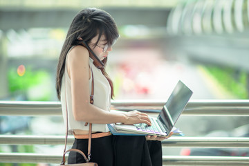 working woman in busy of involve business on street of city town, working online anytime and...