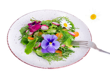 Vegetable salad with edible flowers on white background