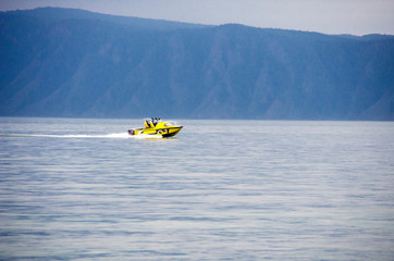 Small boat sailing on the lake