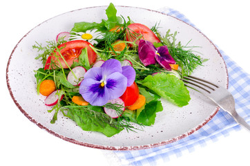 Vegetable salad with edible flowers on white background