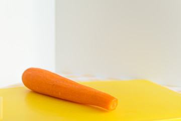 Fresh peeled carrot on cutting board.Selective focus