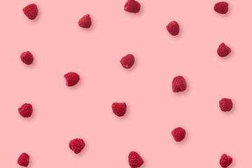 Pattern of raspberry on pink background. Flat lay. Top view. Food background with summer berries. Creative minimalism