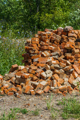 red brick, second-hand lay in a pile on green grass