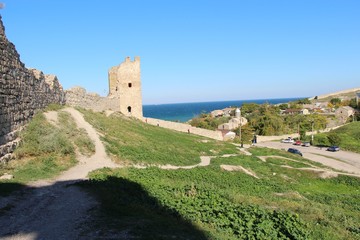 Fototapeta na wymiar Ruins of the Genoese fortress in the city of Feodosia in the Crimea in the autumn under the open sky. Architecture, history, travel and tourism concept.