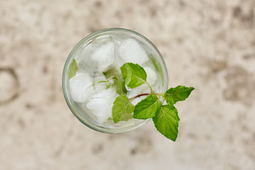 Summer hot fresh drink with mint in glass on white green grey background