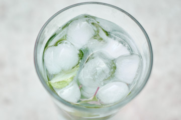 Summer hot fresh drink with mint in glass on white green grey background