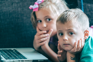 Little children watching cartoons on a laptop