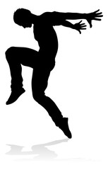 A male street dance hip hop dancer in silhouette