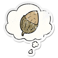 cartoon acorn and thought bubble as a distressed worn sticker