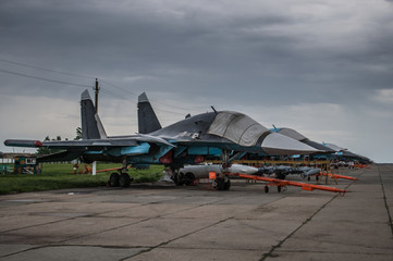 Fototapeta na wymiar Russian military fighter bomber planes Su-34 at closed airfield