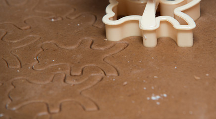 cutting out  a gingerbread with human hand