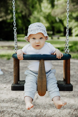 small child is having fun on a swing