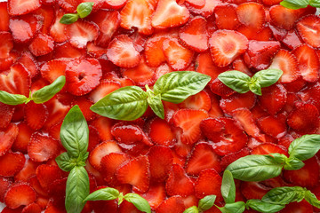 plate of strawberries with sliced ​​basil leaves