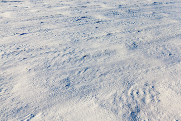 snow-covered soil surface close up - snow-covered soil surface is not smooth. Photographed close-up.
