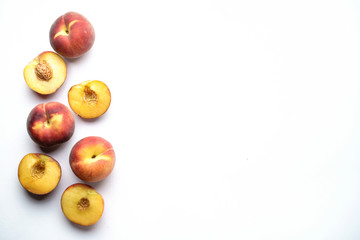 Culinary background, food blog, recipe concept. Layout of ripe sweet peaches on white. Seasonal dessert. Delicious vegetarian meals, diet