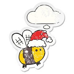 cute cartoon bee wearing christmas hat and thought bubble as a distressed worn sticker