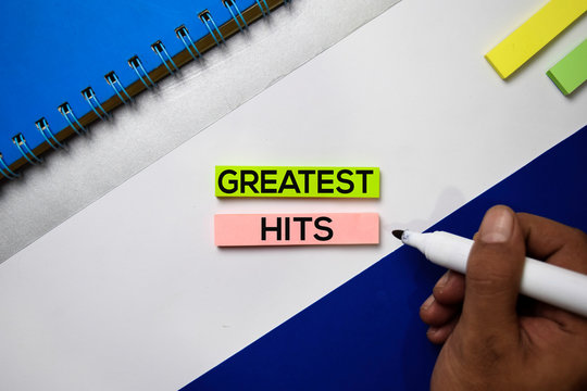 Greatest Hits text on sticky notes with color office desk concept