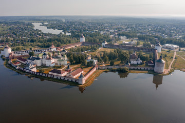 Fototapeta na wymiar Scenic aerial view of old Cyril-Belozersky Monastery in Kirillov. Beautiful sunny summer look of ancient male orthodox monastery with reflection in lake in Vologodskaya oblast in Russian Federation
