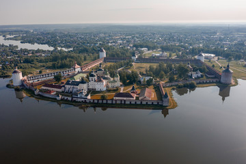 Scenic aerial view of old Cyril-Belozersky Monastery in Kirillov. Beautiful sunny summer look of ancient male orthodox monastery with reflection in lake in Vologodskaya oblast in Russian Federation