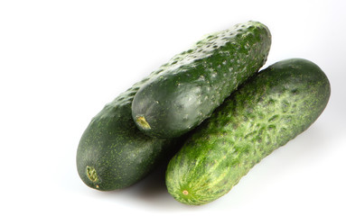 three green cucumber on a white background