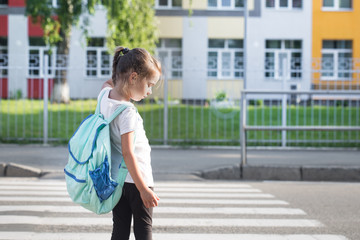 Back to school education concept with girl kids, elementary students, carrying backpacks going to class
