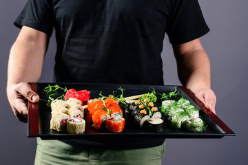 chef with a sushi tray, set rolls sushi japanese asian traditional food