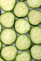 fresh green cucumber, cut with rings on a white background