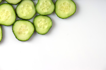 fresh green cucumber, cut with rings on a white background