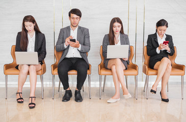 Young Asian business people waiting for job interview in office, occupation and job applying concept