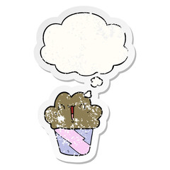 cartoon cupcake with face and thought bubble as a distressed worn sticker