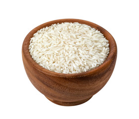 Brown wooden bowl with dry uncooked rice grain