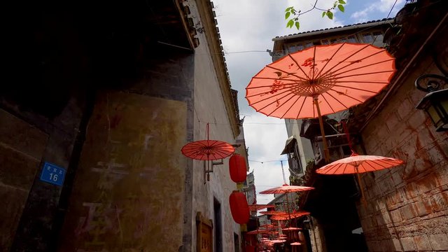Red umbrellas covering narrow streets on Fenghuang ancient town, Hunan province, China